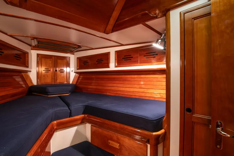 Slide: The Image of Hinckley Sou'wester 42 Sloop 1994 interior cabin with wooden finish and blue cushions. - 39