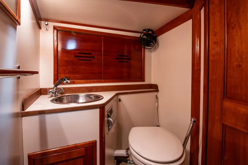 Slide: The Image of Hinckley Sou'wester 42 Sloop 1994 bathroom with wooden cabinetry and stainless steel sink. - 41