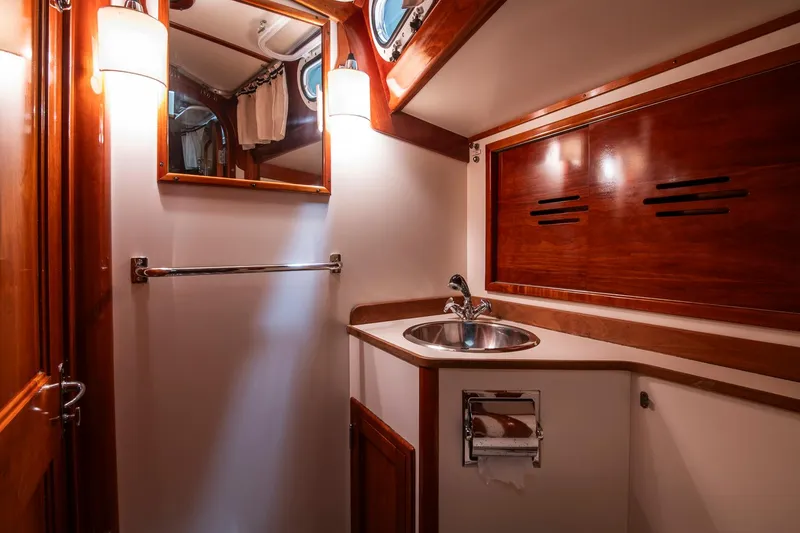 Slide: The Image of Luxurious 1994 Hinckley Sou'wester 42 Sloop bathroom with wood accents and modern fixtures. - 42