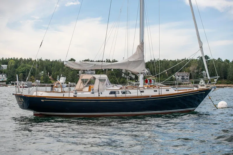 Slide: The Image of Hinckley Sou'wester 42 Sloop, 1994, sailing on calm waters with scenic background. - 6