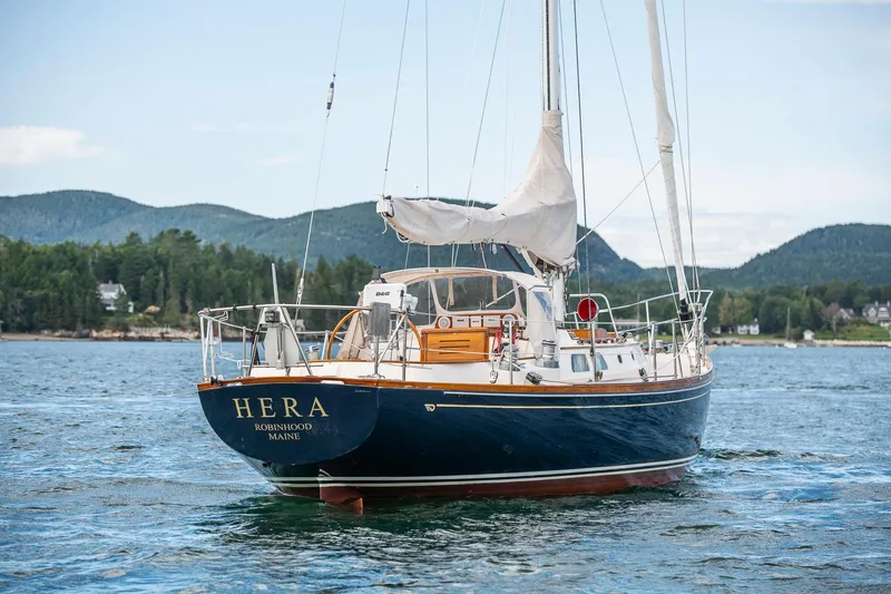 Slide: The Image of Hinckley Sou'wester 42 Sloop, 1994, sailing on a scenic lake with mountainous backdrop. - 8