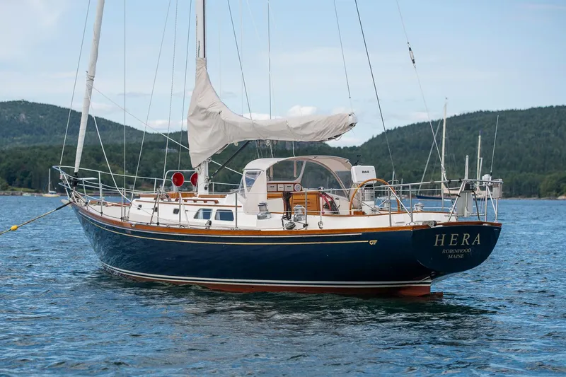 The Image of Hinckley Sou'wester 42 Sloop, 1994, sailing on calm waters with scenic mountain backdrop. - 0