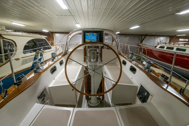 Slide: The Image of Hinckley Sou'wester 42 Sloop 1994, interior view, wooden steering wheel, stored indoors. - 18
