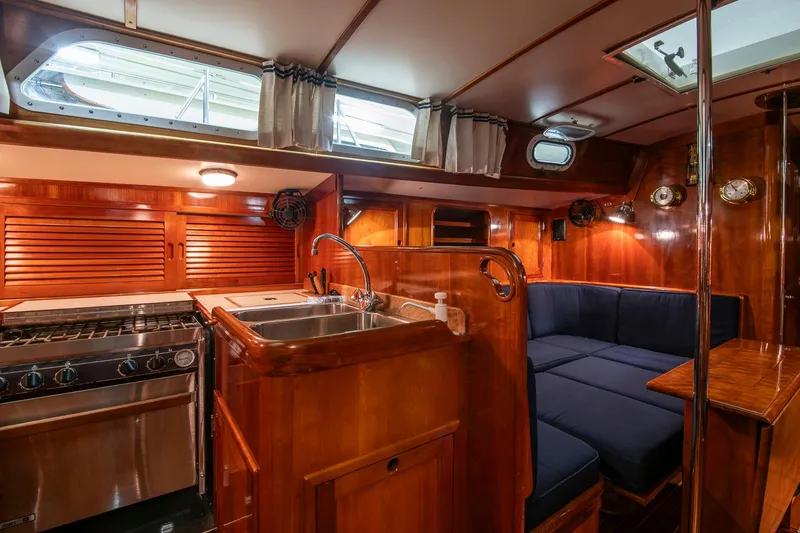 Slide: The Image of Interior of 1994 Hinckley Sou'wester 42 Sloop with wood finish and cozy seating area. - 24