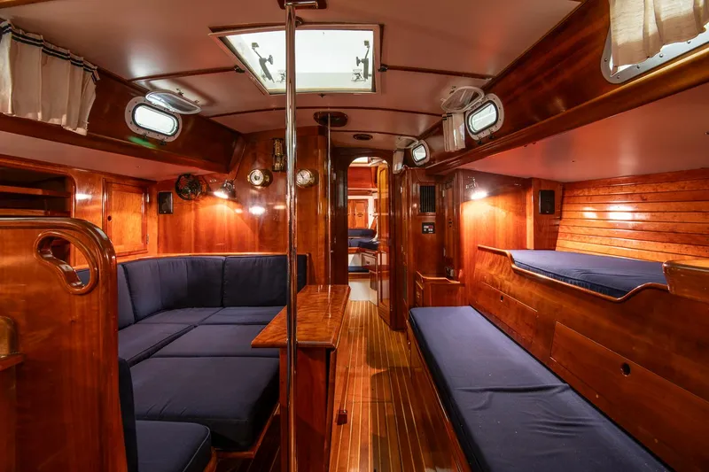 Slide: The Image of Interior of 1994 Hinckley Sou'wester 42 Sloop with wooden finish and blue seating. - 28