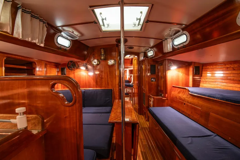 Slide: The Image of Interior of 1994 Hinckley Sou'wester 42 Sloop, featuring polished wood and blue upholstery. - 30