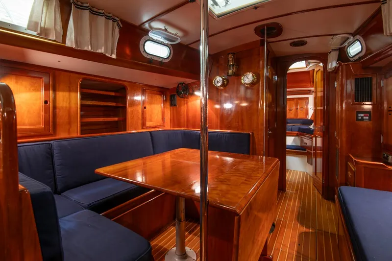 Slide: The Image of Interior of 1994 Hinckley Sou'wester 42 Sloop with wooden finishes and blue seating. - 32