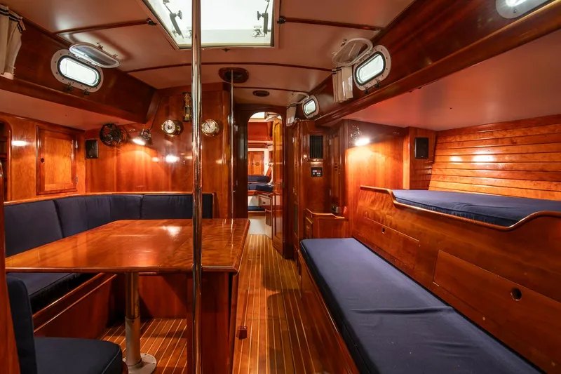 Slide: The Image of Interior of 1994 Hinckley Sou'wester 42 Sloop, featuring polished wood and blue seating. - 33
