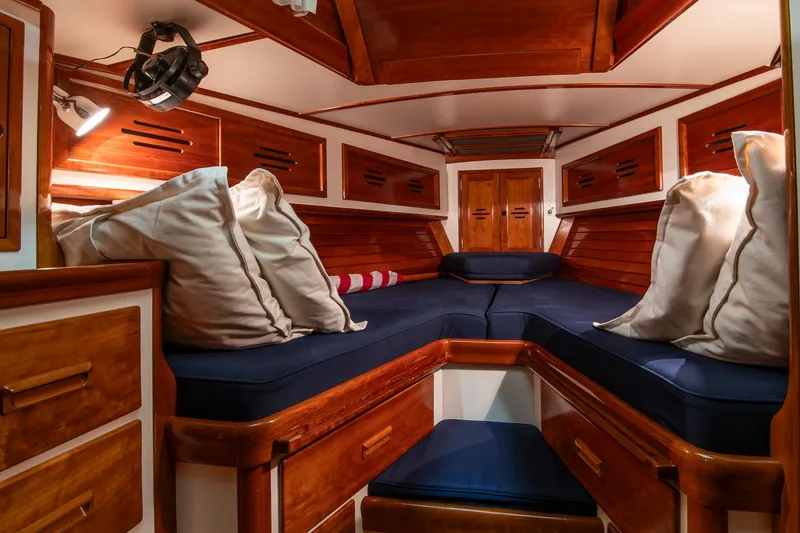 Slide: The Image of Luxurious cabin interior of 1994 Hinckley Sou'wester 42 Sloop with wooden finish and blue cushions. - 37