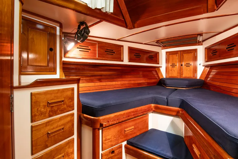 Slide: The Image of Luxurious wooden interior of 1994 Hinckley Sou'wester 42 Sloop with blue cushions. - 38