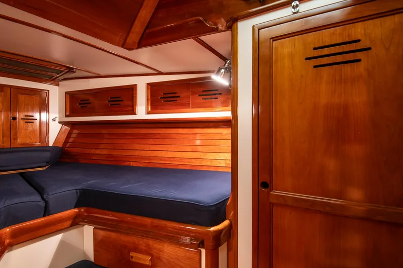 Slide: The Image of Interior of 1994 Hinckley Sou'wester 42 Sloop with wooden cabinetry and blue cushions. - 40