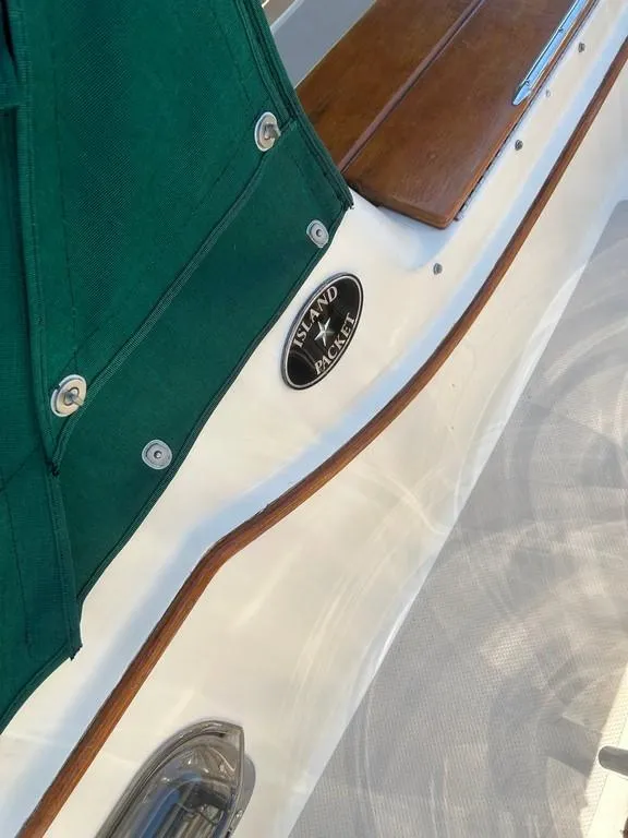 Slide: The Image of 1998 Island Packet 40 sailboat detail with green canvas and wood trim. - 11