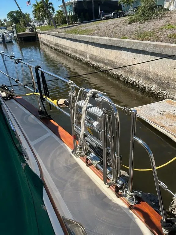 Slide: The Image of 1998 Island Packet 40 sailboat docked, featuring stainless steel ladder and railing. - 12