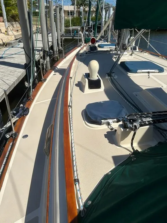 Slide: The Image of 1998 Island Packet 40 sailboat deck with wood trim and green canvas. - 13