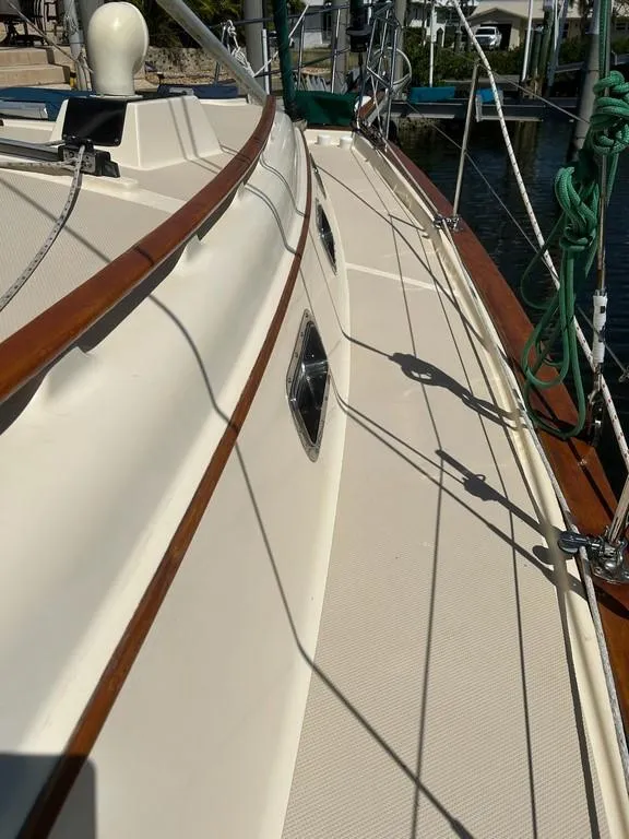 Slide: The Image of 1998 Island Packet 40 sailboat deck with wood trim and rigging details. - 18