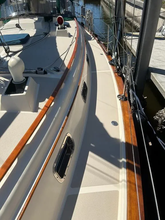 Slide: The Image of 1998 Island Packet 40 sailboat deck with wood trim and docked at marina. - 19