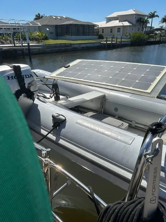 Slide: The Image of 1998 Island Packet 40 with solar panel and Honda motor in a sunny marina. - 20