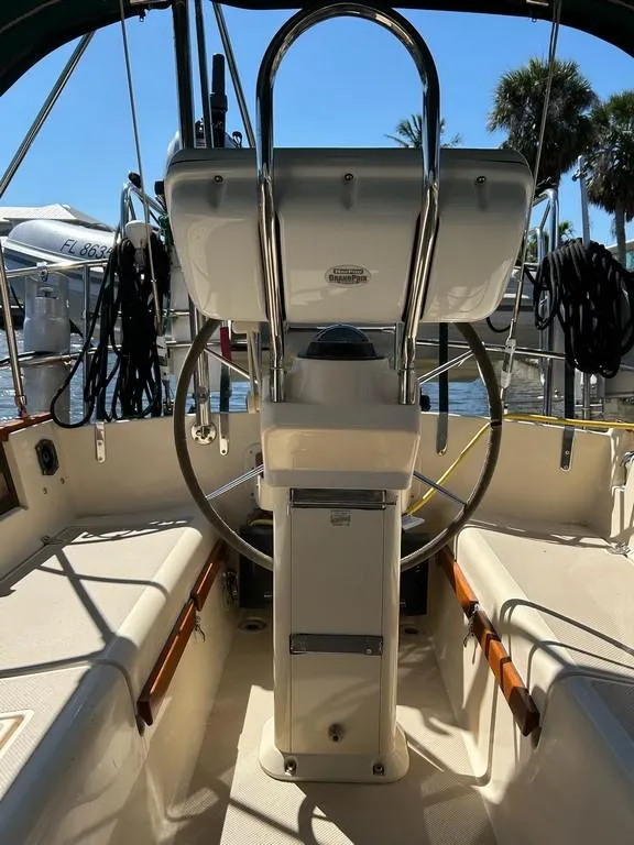Slide: The Image of 1998 Island Packet 40 sailboat cockpit with steering wheel and navigation equipment. - 28