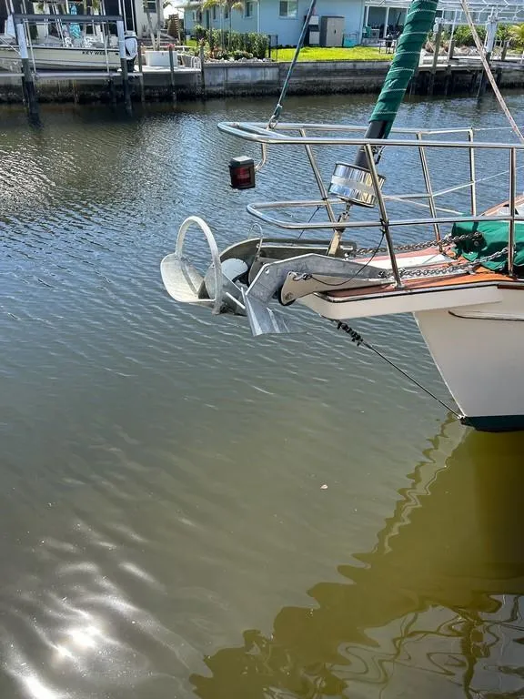 Slide: The Image of 1998 Island Packet 40 sailboat anchored in a calm marina. - 3