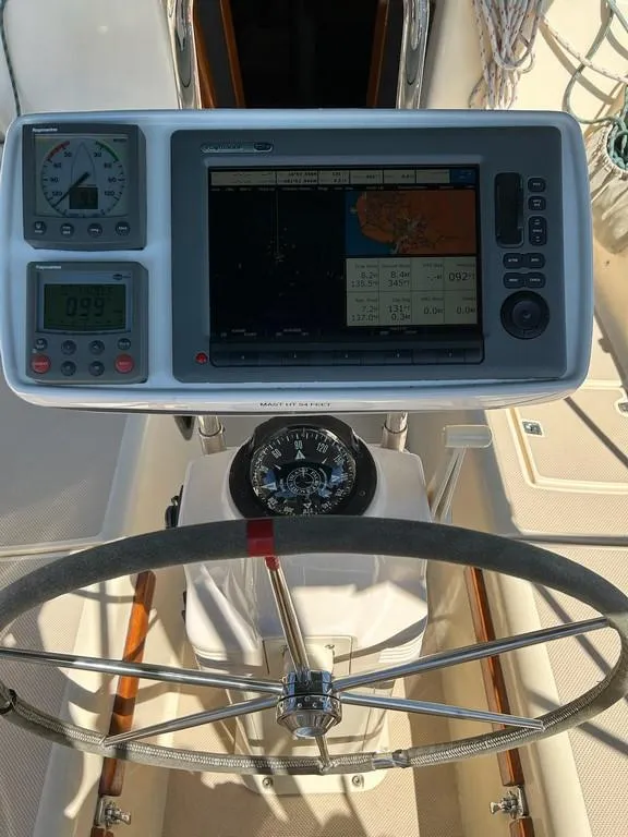 Slide: The Image of 1998 Island Packet 40 sailboat helm with navigation instruments and compass. - 32