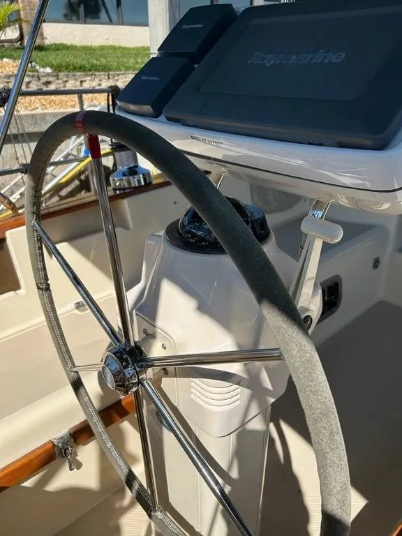 Slide: The Image of 1998 Island Packet 40 sailboat helm with steering wheel and navigation equipment. - 35