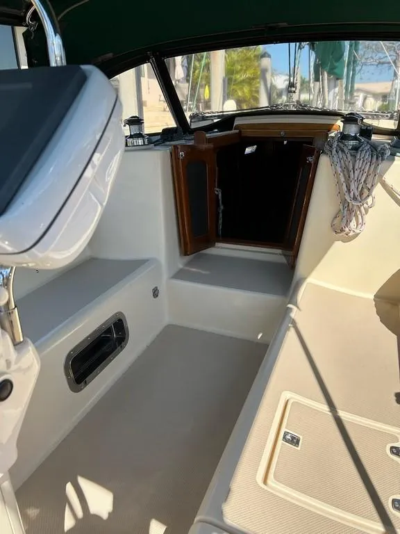 Slide: The Image of 1998 Island Packet 40 sailboat cockpit with open cabin door and seating area. - 36