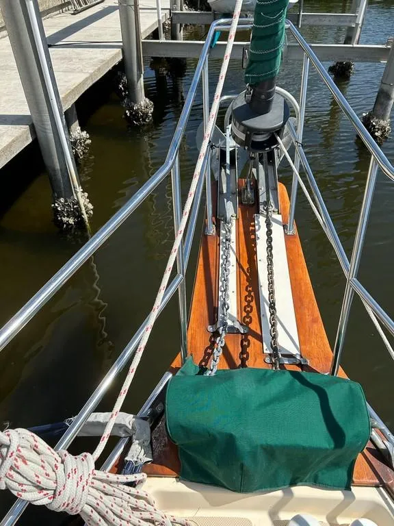 Slide: The Image of Bow of 1998 Island Packet 40 sailboat with anchor and green cover. - 4
