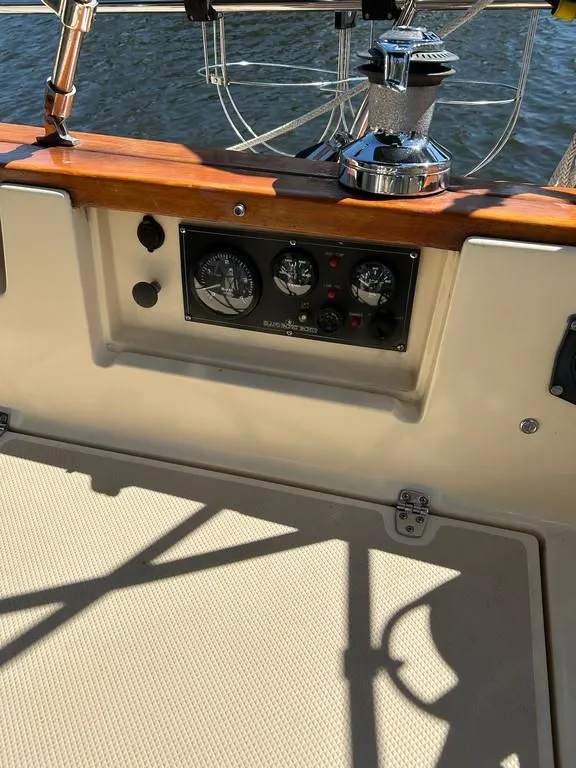 Slide: The Image of 1998 Island Packet 40 sailboat cockpit with control panel and winch. - 44