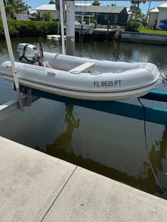 Slide: The Image of Inflatable boat docked by water, featuring registration FL 8635 PT. - 5