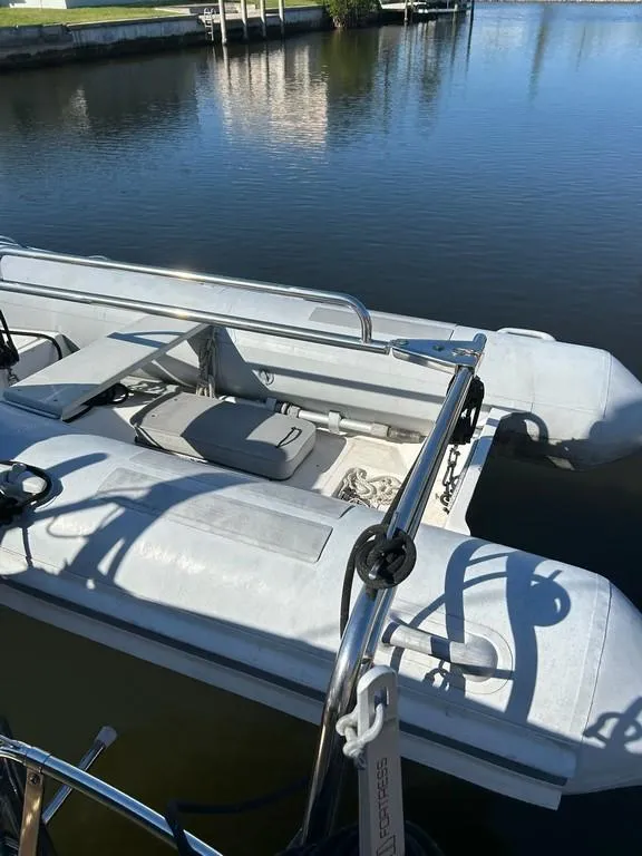 Slide: The Image of Inflatable dinghy docked beside a 1998 Island Packet 40 sailboat. - 8