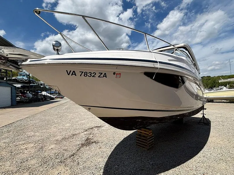 Slide: The Image of 2020 Regal 28 Express boat on dry dock under a partly cloudy sky. - 0