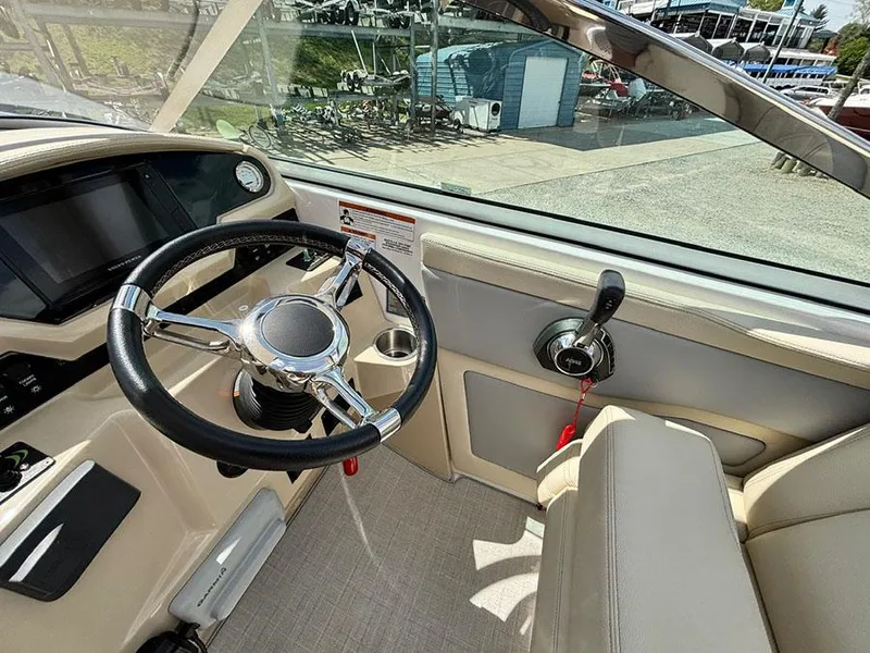 Slide: The Image of Cockpit of 2020 Regal 28 Express boat with steering wheel and control panel. - 1