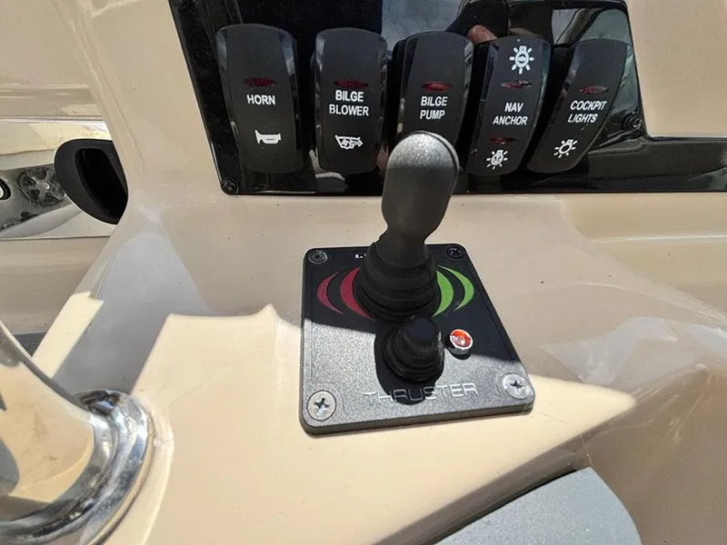 Slide: The Image of Control panel of a 2020 Regal 28 Express boat with joystick and switches. - 3