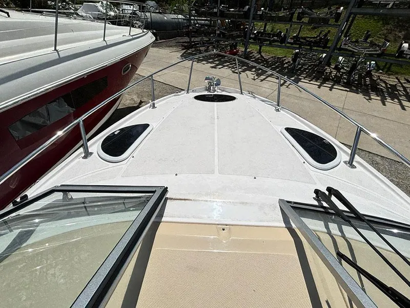 Slide: The Image of 2020 Regal 28 Express boat deck view with open hatch and surrounding marina. - 5