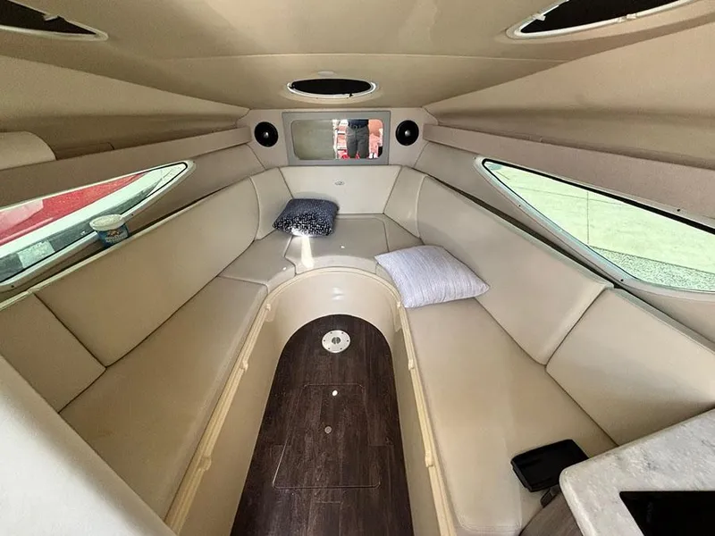Slide: The Image of Interior of 2020 Regal 28 Express boat with beige seating and pillows. - 7