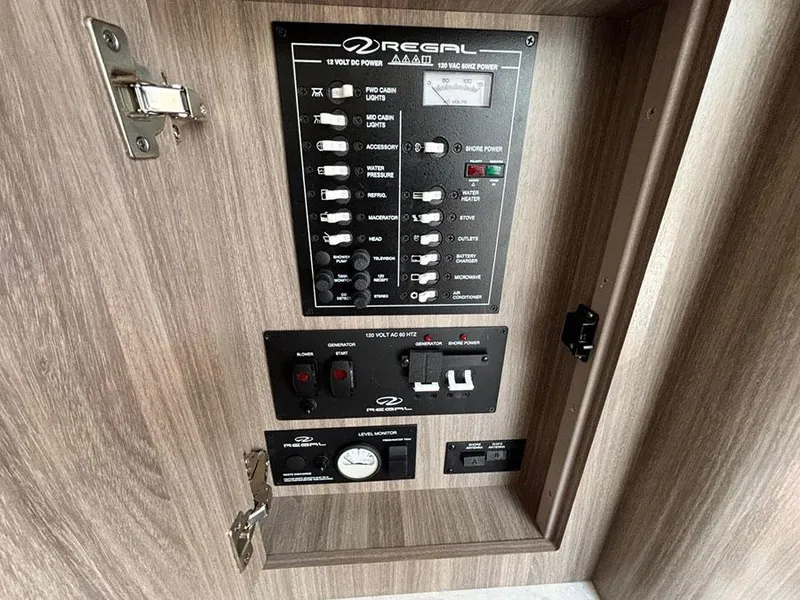 Slide: The Image of Control panel of a 2020 Regal 28 Express boat, featuring switches and gauges. - 9