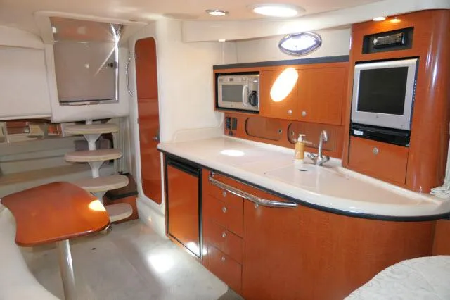Slide: The Image of 2005 Sea Ray 340 Sundancer interior with kitchenette, microwave, and TV. - 13