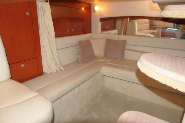 Slide: The Image of Interior of 2005 Sea Ray 340 Sundancer, featuring cozy seating and elegant wood cabinetry. - 14