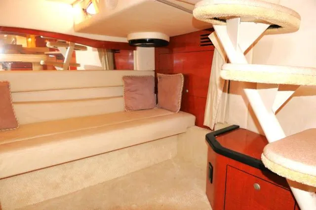 Slide: The Image of Interior of 2005 Sea Ray 340 Sundancer with beige seating and wooden accents. - 18
