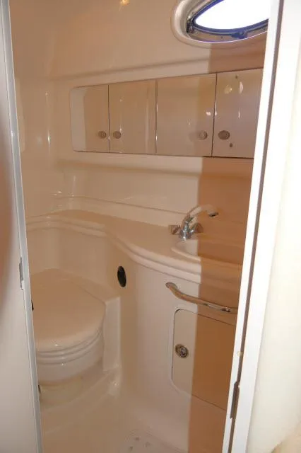 Slide: The Image of 2005 Sea Ray 340 Sundancer bathroom with sink, mirror, and storage cabinets. - 20