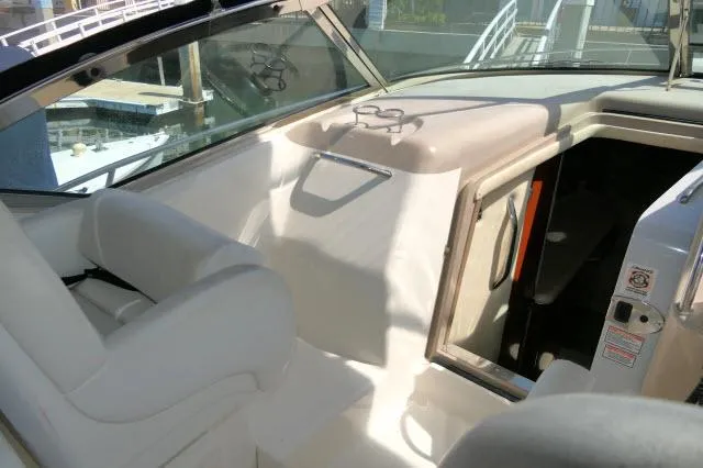 Slide: The Image of 2005 Sea Ray 340 Sundancer boat interior with white seating and cabin entrance. - 23