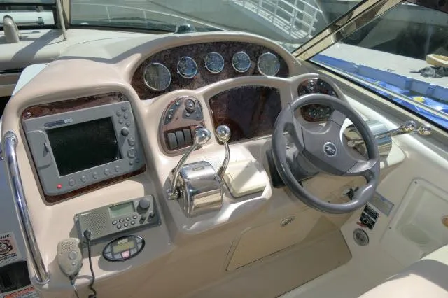 Slide: The Image of 2005 Sea Ray 340 Sundancer helm with navigation controls and steering wheel. - 31