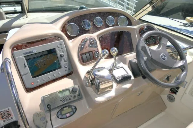 Slide: The Image of 2005 Sea Ray 340 Sundancer helm with navigation system and controls. - 32