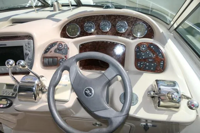 Slide: The Image of 2005 Sea Ray 340 Sundancer helm with steering wheel, gauges, and controls. - 34