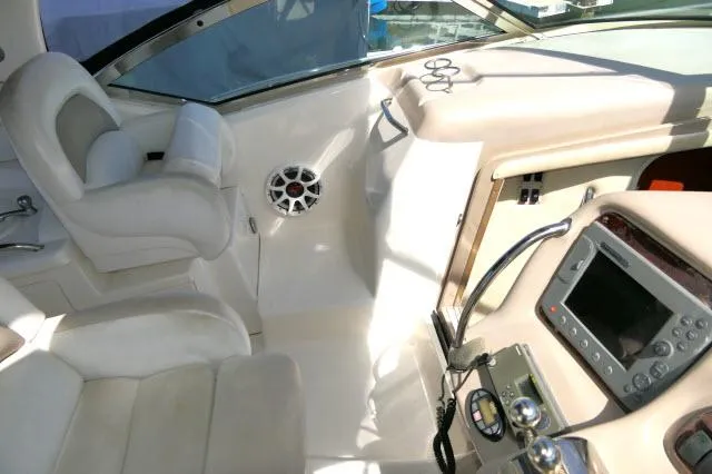Slide: The Image of 2005 Sea Ray 340 Sundancer cockpit with steering, controls, and seating. - 35