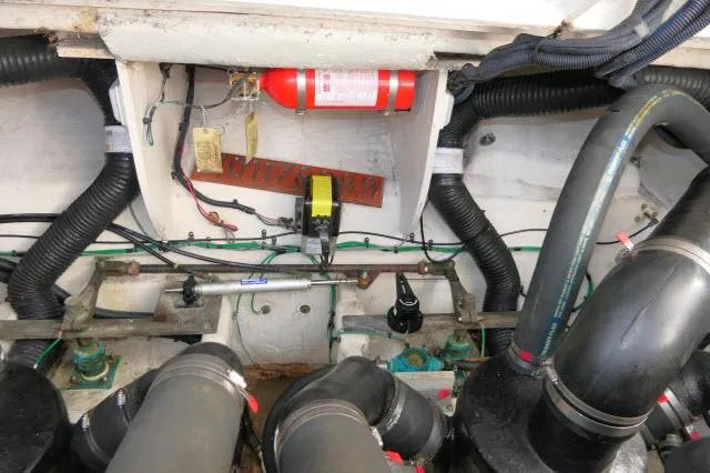 Slide: The Image of Engine compartment of a 2005 Sea Ray 340 Sundancer with visible fire extinguisher and wiring. - 38
