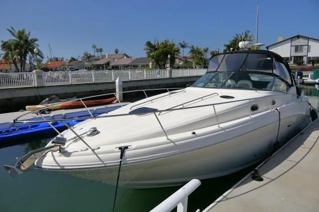 Slide: The Image of 2005 Sea Ray 340 Sundancer docked in a sunny marina setting. - 47
