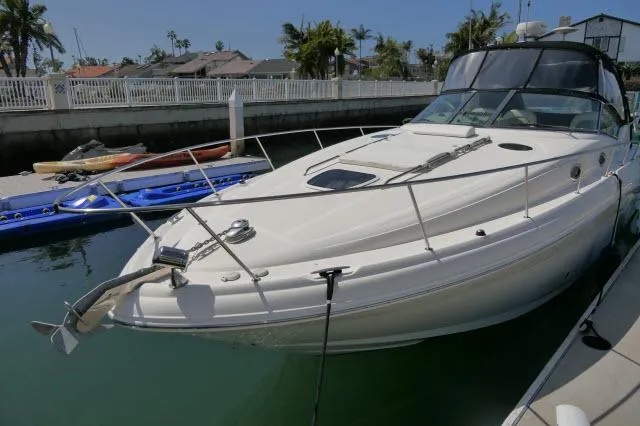 Slide: The Image of 2005 Sea Ray 340 Sundancer docked in a sunny marina setting. - 48