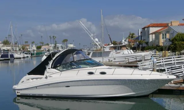 Slide: The Image of 2005 Sea Ray 340 Sundancer yacht docked in a marina, surrounded by other boats. - 49