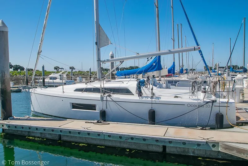 The Image of Sailboat Beneteau Oceanis 30.1, 2022 model, docked at marina under clear blue sky. - 0